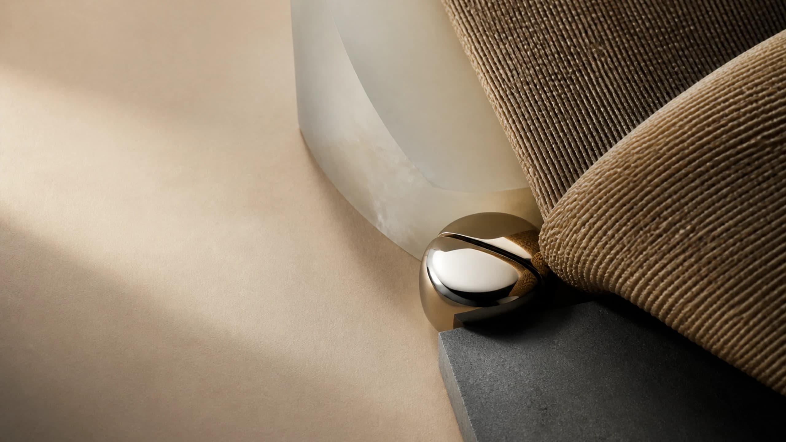 A compact mirror joint pressing into a dense warm woven sweep
