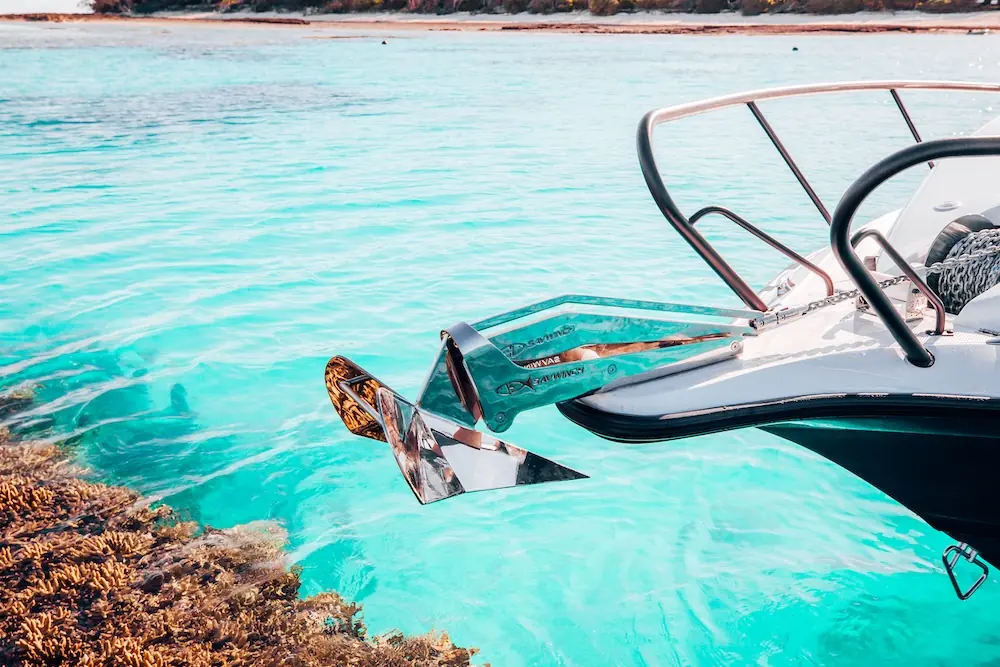 Savwinch anchor winch on the bow of a boat above turquoise water