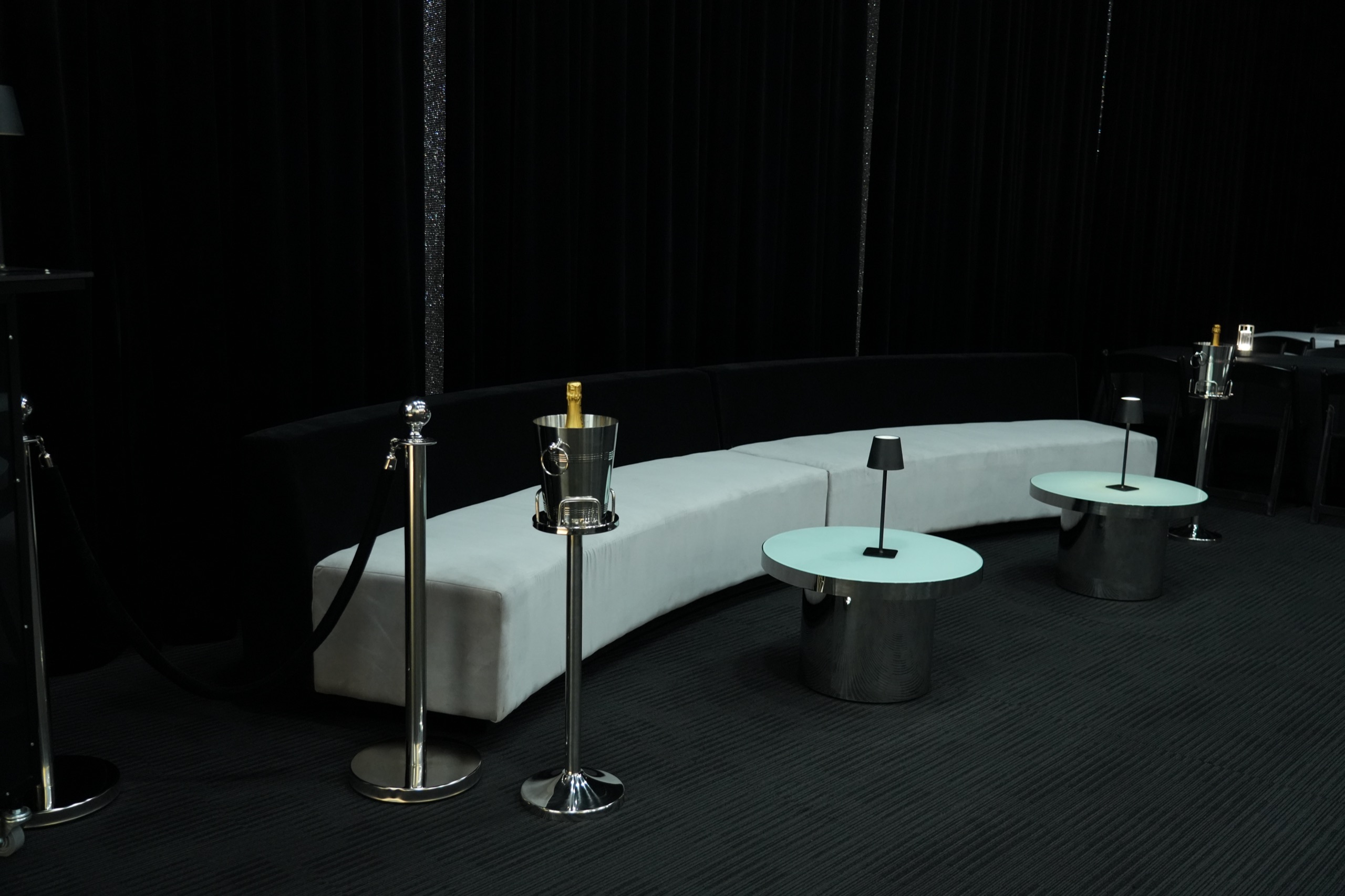 Tomiachi’s white lounge prepared with cocktail tables and champagne service